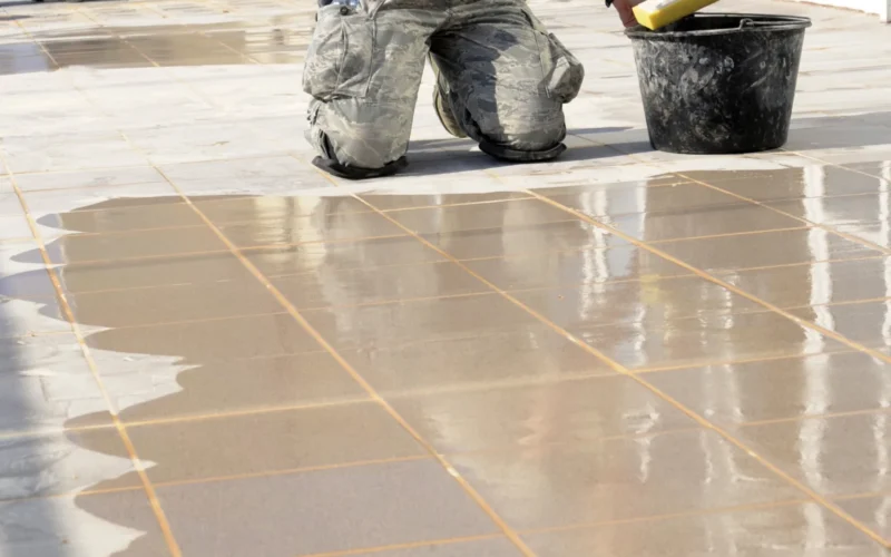 Oregon Air National Guard Senior Airman Megan Brucha, assigned to the 142nd Fighter Wing Civil Engineer Squadron, begins to clean the tile surfaces after grout has dried on the patio at a local health clinic in the city of Mangalia, Romania, May 12, 2015, as part of the U.S. European Command’s (EUCOM) Humanitarian Civic Assistance Program (HCA). The EUCOM HCA program is designed to improve the host nation's critical infrastructure and the underlying living conditions of the civilian populace. (U.S. Air National Guard photo by Tech. Sgt. John Hughel, 142nd Fighter Wing Public Affairs/Released)
