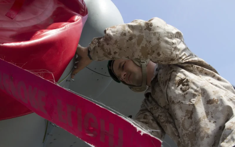Staff Sgt. David Speck, Marine Medium Helicopter Squadron 265 flight equipment staff noncommissioned officer-in-charge, checks the fire bottles to an MV-22 Osprey's exhaust port at the Marine Corps Air Station Iwakuni tarmac here July 25, 2012. This marks the first MV-22 Osprey aircraft deployment to Japan and a milestone in the Marine Corps' process of replacing CH-46E helicopters with the MV-22 Osprey, a highly-capable, tiltrotor aircraft which combines the vertical capability of a helicopter with the speed and range of a fixed-wing aircraft.