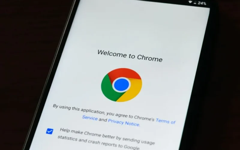 Close-up of smartphone displaying Google Chrome's welcome page and logo.