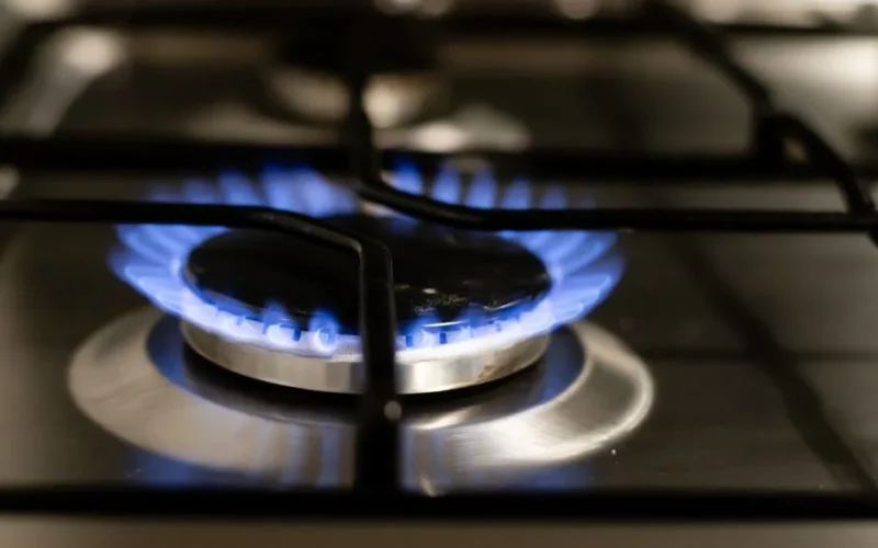 A detailed view of a blue flame on a stove, showcasing energy and heat.