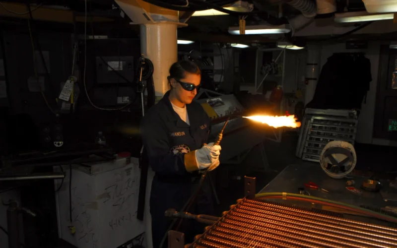 BREMERTON, Wash. (Oct. 18, 2010) Hull Maintenance Technician fireman Christina Swanson, from Minneapolis, Minn., brazes on a new fitting on a radiator in the sheet metal shop aboard the Nimitz-class aircraft carrier USS John C. Stennis (CVN 74). John C. Stennis is moored at Puget Sound Naval Shipyard undergoing a maintenance period in its homeport. (U.S. Navy photo by Mass Communication Specialist 3rd Class Will Tyndall/Released)