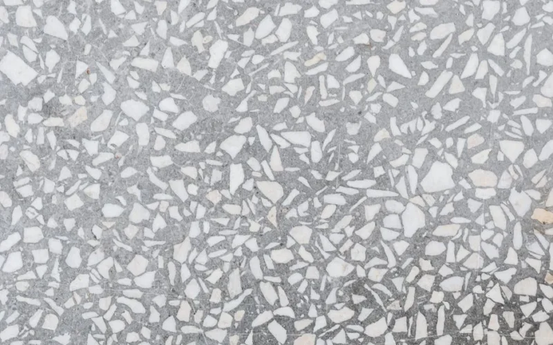 High-resolution image of a classic terrazzo stone texture with white and gray patterns.