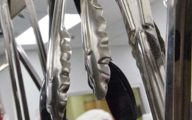 Tools of the culinary trade are clean and ready for use by student chefs Ed Rivas (left) and David Rodriguez (right) at San Antonio Food Bank (SAFB) Community Kitchen in San Antonio, TX, on Monday, October 31, 2011. The Community Kitchen trains the unemployed, feeds the hungry, and generates public support and revenue through social enterprise. Their classroom is seen in the background. Along with catering services, they also prepare meals for the U.S. Department of Agriculture (USDA) Summer Food Service Program feeding children during summer months, and the year-round Child and Adult Care Feeding Program (CACFP). They began creating meals in 2003, with volunteers and the Community Kitchen students looking to further themselves in a promising culinary career. Over the 16-week course individuals receive basic culinary training, similar to portions of an accredited culinary institution, to develop their culinary job skills. The program is lead by Chef Rudy Garza and his team of instructor chefs, present training and work demands that build useful job skills. The students focus their new talents on the preparation of meals for area shelters, kids cafes, summer feeding sites (www.summerfood.usda.gov/), and catering services. San Antonio Food Bank is a non-profit organization that serves as a clearinghouse by receiving and storing truckloads of donated food, produce, and other grocery. SAFB distribute these items to over 500 service agencies that help people in need. “We couldn’t do what we do without our partnership with USDA’” said President and CEO Eric Cooper. He continues, “We are privileged in partnering (with the USDA) to feeding kids, through the summer, with the Summer Food Service Program, and throughout the year, with the Child and Adult Care Feeding Program (CACFP). Then in our approach to feeding seniors, we partner with USDA in the Commodities Supplemental Food Program (CSFP), and the Senior Farmer’s Market (Nutrition) Program. And then work to bring all our (needy) parties together with our Supplemental Nutrition Assistance Program (SNAP) Outreach. You know, once families have access to food we believe it is important to educate them. Through the support of the SNAP-Education Program we are able to educate them during their time of need. With this comprehensive approach we are really able to get the right food, at the right amount, at the right time, to needy families throughout our community – which allows us to feed the fifty-eight thousand we do, each week.” SAFB serves 16 counties in Southwest Texas and states, “Nearly one out of every four children and one out of every five adults in Southwest Texas lives in poverty and has difficulty meeting basic nutritional needs.” According to SAFB, sixty-five percent of the people requesting emergency food have children. “Additionally, the senior citizens and those living on a fixed income generally have limited funds for a consistent grocery budget.” San Antonio is the seventh largest city in the nation with surrounding farms and ranches near its rivers and water supplies. When available they provide fresh surplus produce. Other commodities come from the food industry and manufacturers. The major food brand companies that for various reasons have surplus commodities donate it to SAFB. The United States Department of Agriculture donates commodities through programs such as The Emergency Food Assistance Program (TEFAP), while Texas farmers supply fresh produce to their Fresh Produce Program. Public donations come in the form of money, food, volunteer time, and advocacy. Their fleet of trucks to pickup and deliver food as needed. USDA photo by Lance Cheung www.fns.usda.gov/fns/ www.fns.usda.gov/snap/ www.fns.usda.gov/fdd/programs/tefap/ www.summerfood.usda.gov/
