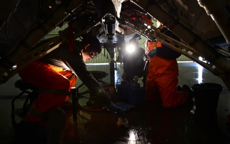 U.S. Air Force crew chiefs from the 31st Aircraft Maintenance Squadron lube pivot points underneath an F-16 Fighting Falcon after washing the aircraft, March 17, 2015, at Aviano Air Base, Italy. To assist with crew chiefs’ frequent inspections, Aviano aircraft receive a thorough cleaning using soap, water and lube every 180 days. (U.S. Air Force photo by Senior Airman Matthew Lotz/Released)