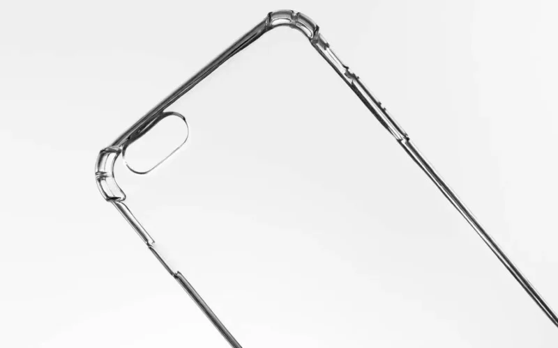 Close-up of a transparent phone case against a light background, showcasing sleek design.