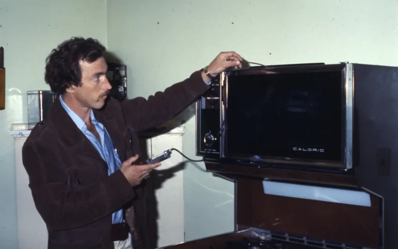 William Roger Ross, a Development Assistant with the City of Columbus Department of Development, Division of Housing Inspection, inspects a Caloric gas range.