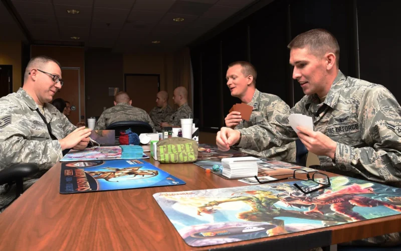 Staff Sgt. Jeffery Davis, 4th Space Operations Squadron supervisor of protected satellite communication maintenance, Capt. Portmann Werner, former 50th Space Wing Chaplain, and Airman 1st Class Charles Langdon, 50th Operations Support Squadron student, play a card game during Geek Lunch at Schriever Air Force Base, Colorado, Jul. 12, 2016. Starting Feb. 26, Lunch Box Games will replace Geek Lunch, bringing new games and consoles. (U.S. Air Force photo by Staff Sgt. Matthew Coleman-Foster)