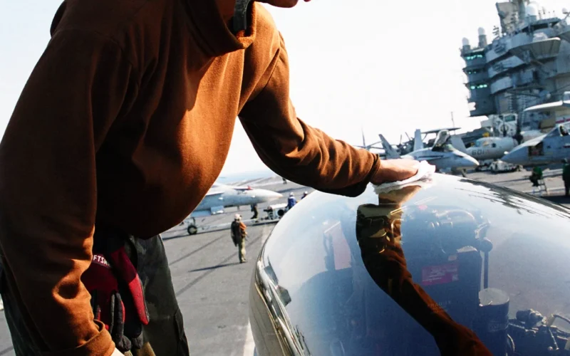 At sea aboard USS Abraham Lincoln (CVN 72) Nov. 12, 2002 -- Airman Thomas Taylor from Washington, D.C., cleans the canopy of an F/A-18F “Super Hornet” as part of his pre-flight maintenance preparations. The Lincoln and Carrier Air Wing Fourteen (CVW-14) are on a regularly scheduled six-month deployment conducting combat missions in support of Operation Enduring Freedom and Operation Southern Watch. U.S. Navy photo by Photographer's Mate 2nd Class Dan J. Mark. (RELEASED)