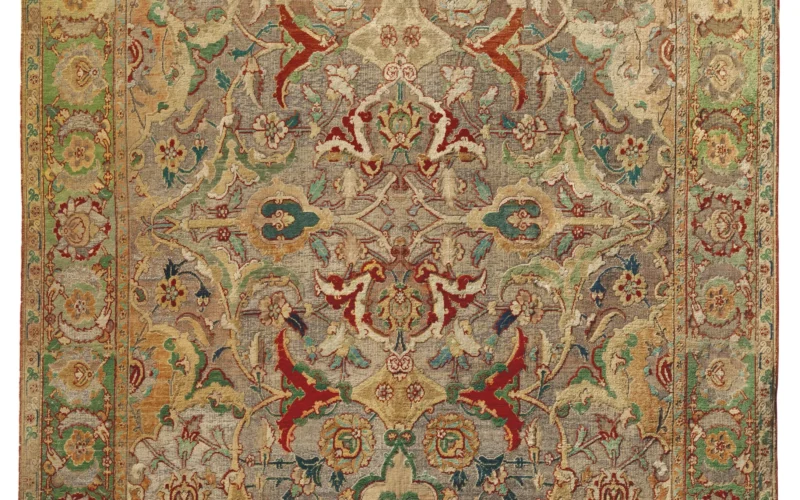 A HIGHLY IMPORTANT SAFAVID SILK AND METAL-THREAD 'POLONAISE' CARPET PROBABLY ISFAHAN, CENTRAL PERSIA, EARLY 17TH CENTURY The field centred by a quatrefoil medallion formed of inverted palmettes linked by delicate flowering stems that extend into the field forming curvaceous arabesques terminating with maroon red, forest-green or burnished gold split-palmettes, framed within a shaded grass-green border of palmettes alternating with individual flowerheads enclosed within paired saz leaves between pale peach floral meander minor stripes, with an extensive colour palette and considerable silk pile throughout, overall excellent condition 6ft.5in. x 4ft.6in. (197cm. x 141cm.) This important and rare silk and metal-thread Polonaise carpet is the perfect marriage of beauty, artistry and exoticism. It previously formed part of the esteemed art collection of Baron Adolphe Carl von Rothschild (1823-1900), known affectionately as ‘Dolly’. Adolphe von Rothschild was the son of Carl Mayer von Rothschild (1788-1855), a member of the great banking dynasty whose political, economic and cultural achievements were so successful and ubiquitous, that they seemed almost untouchable in relation to other familial dynasties of the 19th and 20th centuries. Rooted in Frankfurt, London, Paris, Vienna and Naples, Adolphe remained in Naples where he was appointed General Consul of the Duchy of Parma. Less renowned for his banking prowess but more as an art connoisseur with exquisite taste, Adolphe took the bold decision in 1865, to become the first family member to leave the partnership in order to devote his time to building a significant and important art collection. It took a further two years of arduous negotiation before he was able to successfully step down from his familial duties. In 1857 Adolphe bought Châteaux de Pregny on the shores of Lake Geneva, but his time was also spent in Paris at rue de Monceau, located in a fashionable area inhabited by similarly wealthy banking families such as the Ephrussi, Camondo and the Goüin. In 1868 Adolphe, who already owned 45 and 49 rue de Monceau, purchased no 47 from Princess Mingrelie and the Marquess de Fernandin. With the help of the family architect, Felix Langlais, Adolphe continued to make alterations to the building which included a single story extension with a glazed roof that would house a ballroom, a conservatory and a smoking room. Adolphe’s wife, Julie, whom he had married in 1850, shared his passion for fine art but where he favoured the Middle Ages and the Renaissance, his wife appreciated fine French furnishings of the 18th century. Together they filled the house with treasures which were sensitively displayed in bespoke galleries illuminated from above with natural light from the glazed ceilings. Upon Adolphe’s death at rue de Monceau in 1900, the house passed to his wife and, following her death in 1907, later passed to Adolphe’s cousin, Maurice de Rothschild (1881-1957), second son of Edmond James de Rothschild (1845-1934). Sadly the house was demolished in the 1970’s but we can see from this watercolour, that the interiors were indeed sumptuous and that textiles and oriental carpets were greatly admired and were integral to the collection. This 'Polonaise' carpet remained in Maurice de Rothschild’s collection for a further sixty years until after his death in 1957, when a legendary sale took place in Paris in 1968 at Palais Galliéra containing a group of no less than twelve 'Polonaise', from an anonymous private collection, but which was widely acknowledged as being that of Maurice de Rothschild. We can be certain that this 'Polonaise' carpet was once part of Adolphe’s collection as, remarkably, it still retains the original cloth hand-stitched label, noting that it was formerly in the, “appartement au Baron Adolphe de Rothschild, 45 rue Monceau”. Depicted in black and white within a slim, partially illustrated catalogue, the present 'Polonaise' was clearly considered to be the best of the group as it was displayed in full colour upon the front cover. The carpet was acquired at the auction by the New York branch of the renowned gallery Rosenberg & Stiebel, who themselves had a long and loyal relationship with the Rothschilds and indeed with many of continental Europe’s noble and aristocratic families. The gallery parted with the carpet a year later in 1970, when it was purchased by a private collector in whose noble family it has remained. At the time, the art historian and curator of the Near Eastern Art at the Metropolitan Museum of Art , New York, Dr. Maurice Dimand, had encouraged the sale by writing to his client that the Rosenberg and Stiebel carpet was,“….a very fine piece, which I would date to the first half of the seventeenth century.” THE ROYAL COURT OF SHAH ABBAS’ THE GREAT The decision of Shah ‘Abbas I (1587-1629) to move his capital city from Qazvin to Isfahan in 1598, was to become the crowning glory of his imperial achievement. Under his reign, Isfahan arguably became the most beautiful city in Iran, filled with palaces, mosques, gardens and squares of breath-taking beauty. In contrast to the previous shah of note, Shah Tahmasp, who had been strongly influenced by his deep religious fervour, which had resulted in the closure of nearly all the royal workshops, Shah ‘Abbas welcomed foreigners with their trade and innovations in all fields. He appointed an Englishman, Sir Robert Shirley, as his ambassador, to visit the courts of Europe and establish important political relations with Persia. The artistic renaissance encouraged a variety of different art forms to flourish from calligraphy, painting and metalwork and of course, carpet and textile production. Shah ‘Abbas had a great appreciation for sumptuous textiles, silks and woven carpets and production in Isfahan rapidly grew under his patronage. The present carpet is testament to the inspirational designs and techniques produced in the new weaving ateliers. The results of the recent scientific Carbon 14 test clearly demonstrate that the vast probability is that this rug was made well within his reign. Silk was one of the most costly materials available and, as such, was reserved almost exclusively for the courts use. A number of workshops would have been working specifically on personal commissions for the shah which would have been appreciated within his palaces. Two such carpets are known to have been given in royal waqf to the great Shiite shrine of the Imam ‘Ali at Najf. European visitors travelling to Persia at the time, commented specifically on the richness of the silk textiles and carpets that they saw. John Fryer in 1676 notes that Isfahan had special bazaars handling the sale of rugs “both woolen and silk, intermixed with Gold and Silver, very costly, which are the peculiar manufacture of this country” (quoted by M. S. Dimand and Jean Mailey, Oriental Rugs in the Metropolitan Museum of Art, New York, 1973, p.59). Other travellers who commented on the silk weavings in both Kashan and Isfahan, include Pater Florentino de Nino Jesus in 1607-08, Thomas Herbert in 1627-8 and Jean-Baptiste Tavernier in 1676. 'POLONAISE' CARPETS The design of ‘Polonaise’ carpets saw a major departure from traditional Persian carpets. Until this point carpet designs adopted a single ground colour within the field, maybe another secondary colour within the medallion, or rarely, a reciprocal design of two colours for the border. The earliest Kashan silk and metal-thread carpets follow the same concept, with monochrome metal-thread fields (Arthur Upham Pope, A Survey of Persian Art, Oxford, 1938, pls. 1242 &1243). Shortly after this the designers began using the irregularly shaped panels formed by the scrolling foliate arabesques to create individual fields, each of which was defined by a different ground colour, a technique already long established in manuscript illumination. The field design of this carpet demonstrates this feature very well, through a complex interlocking arrangement of forms each of different coloured silks and gold and silver metal-threads, overlaid with a fine lattice of leafy vine and arabesques. A significant proportion of 'Polonaise' carpets made at the time, were gifted by the Shah as ambassadorial gifts to European royalty and nobility, foreign emissaries and leaders of trade delegations. They were hugely appreciated by the Baroque nobility of the 17th century courts, Louis XV apparently owned twenty five such rugs with precious silk and metal thread. The Polish royalty in particular held a deep fascination for such Persian works of art. Records show that in as early as 1584, King Stephen Bathory (r.1576-1586) acquired thirty-four Persian textiles, while in 1601 a group of eight Safavid silk carpets embellished with gold was ordered by Sigismund Vasa III of Poland for his daughter’s wedding, (Axel Langer, The Fascination of Persia, Zurich, 2013, p.121). These appear to have been delivered in 1602, some or all of which then passed by marriage into the Wittelsbach family and are now in the Residenz Museum in Munich. Further examples remain in noble European collections today such as those of the Swedish and Danish royal families, the Princes of Lichtenstein, the royal house of Savoy in Italy, the Duke of Buccleuch and the Papal collection in the Vatican. The term 'Polonaise', was first coined at the Paris Universal Exhibition in 1878 where, in the Polish section of one of the pavilions, examples of this group of carpets belonging to Prince Czartoryski, some bearing his recently added personal coat of arms, were exhibited publicly for the first time (Kurt Erdmann, Europa und der Orientteppich, Mainz, 1962, pl.36. pp.8405). Visitors and journalists mistakenly concluded that these carpets had been woven in Poland and it wasn’t until after the exhibition had closed, that the true origin was discovered. The Polish attribution has persisted and continues to be used today.