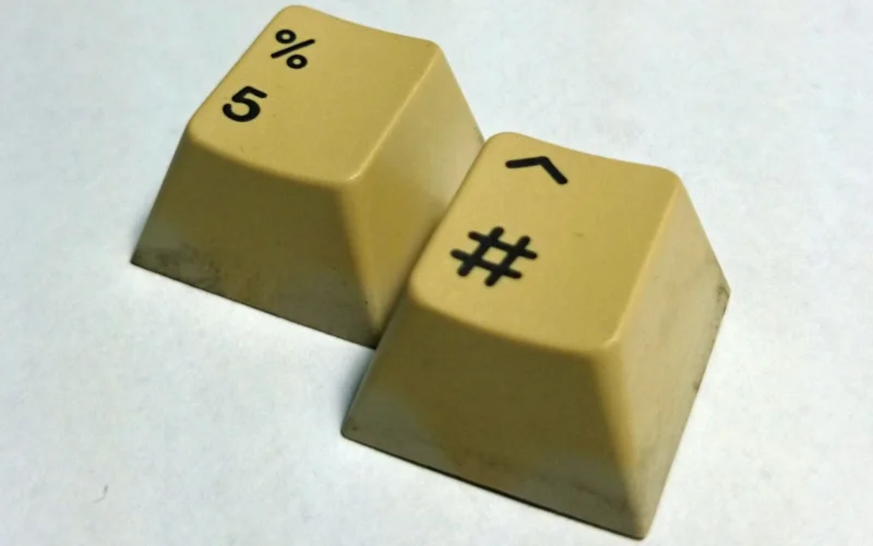 Two yellowed Cherry mount keycaps before being Retr0brighted.