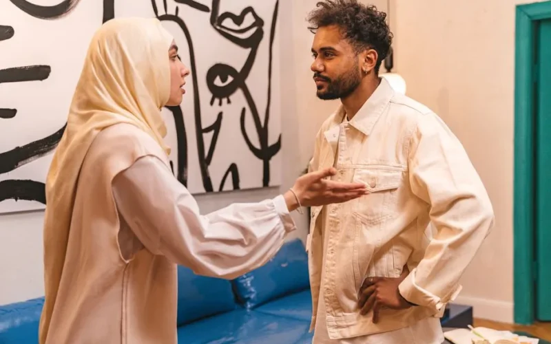 A man and woman in an intense conversation at home, evoking emotions.