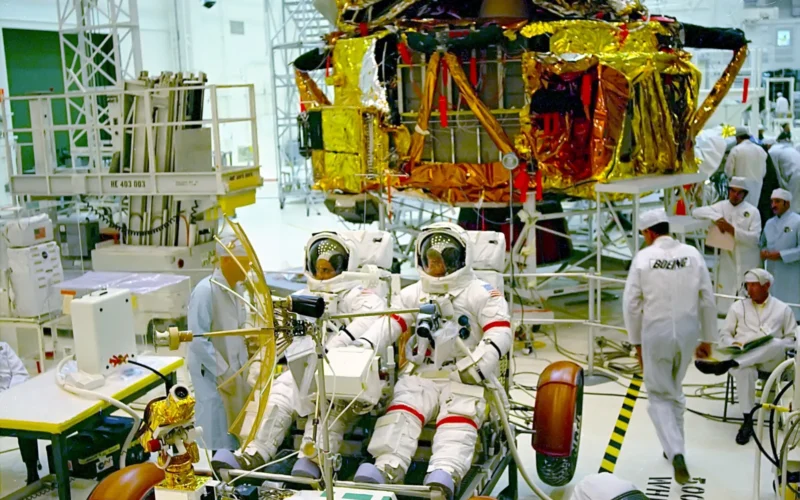 Apollo 17 Commander Eugene A. Cernan and Lunar Module Pilot Harrison H. Jack Schmitt are preparing the Lunar Roving Vehicle (LRV) and the Communications Relay Unit (LCRU) mission simulation. Support Team Astronaut Gordon Fullerton, standing, left, discusses test procedures to be performed in the High Bay of the Manned Spacecraft Operations Building (MSOB). The Lunar Module Ascent and Descent stages also receive preflight checkout in preparation for the sixth U.S. manned lunar landing mission.