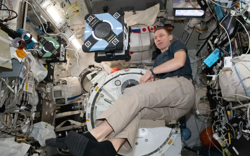 iss069e008378 (May 2, 2023) --- NASA astronaut and Expedition 69 Flight Engineer Woody Hoburg tests one of the space station’s Astrobee robots for Zero Robotics, a student competition to write software to control the free-flying robots. The program promotes teamwork and awareness of space career opportunities and students learn about artificial intelligence, systems engineering, and human-robot collaboration.