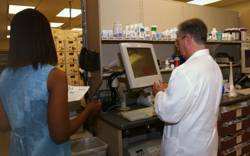National Naval Medical Center, Bethesda, Md., (Aug. 19, 2003) -- Pharmacist Randal Heller, right, verifies the dosage and medication of a prescription at the National Naval Medical Center in Bethesda, Maryland. Heller checks all prescriptions dispensed at the pharmacy before they are handed over the counter to the patient. Heller is retired as a Commander from the Navy Medical Service Corps. U.S. Navy photo by Chief Warrant Officer 4 Seth Rossman. (RELEASED)