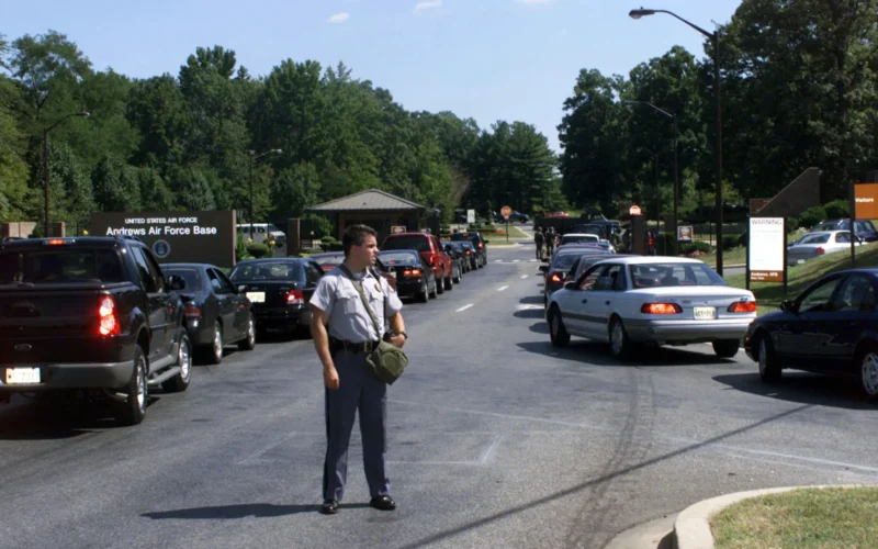 A Morningside, Maryland, police officer helps direct traffic into Andrews AFB, on September 11, 2001. Note that the officer is carrying a gas mask in its pouch. The traffic jam and gas mask precaution is a result of the terrorist attack on the Pentagon initiating a lock down and inspection of all vehicles entering the base.