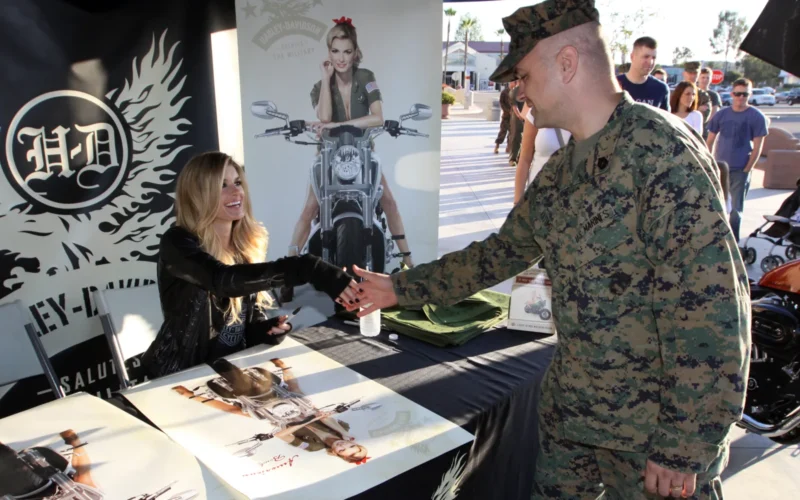 Super model and actress Marisa Miller shakes hands with Gunnery Sgt. Charles Vittamo, instructor, Amphibious Assault School Battalion, Camp Pendleton, during her visit to the base’s Country Store, Nov. 9. Miller, who graced the cover of the 2008 Sports Illustrated Swimsuit issue, visited the base to sign autographs and express her support to service members. More than 100 enthusiasts waited in line for their chance to meet with the Victoria Secret Angel and posed for pictures. During the event attendees received a ticket for a chance to win one of three Harley Davidson motorcycles, which were on display during the affair.