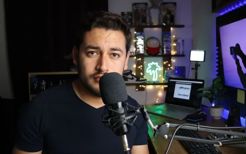 Podcaster in a stylish home studio with microphone and neon lights in Santiago de Querétaro, Mexico.