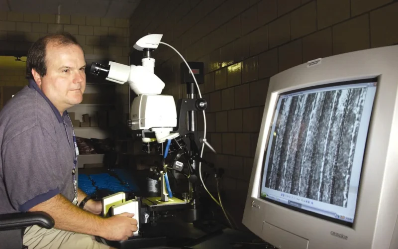 AMES TECHNICIAN OBSERVING A UNIQUE TOOLMARK EMBEDDED IN THE SURFACE OF AN ORDINARY PAIR OF PLIERS USED IN A FORENSIC STUDY. A FORENSIC COMPARISON MICROSCOPE IS USED TO CAPTURE DIGITAL IMAGES OF TOOLMARKS, WHICH ARE ENTERED INTO A DATABASE. FORENSIC EXPERTS CAN USE THE DATABASE TO IDENTIFY TOOLMARKS PRODUCED ON A TOOL THROUGH DIFFERENT MANUFACTURING PROCESSES. IT IS KNOWN IN THE FORENSIC COMMUNITY THAT DURING THE MANUFACTURING PROCESS OF TOOLS, SUCH AS SCREWDRIVERS, PLIERS, OR WIRE CUTTERS, MARKS ARE EMBEDDED ON THEIR SURFACES, MAKING PATTERNS THAT RENDER EACH TOOL UNIQUE. For more information or additional images, please contact 202-586-5251.