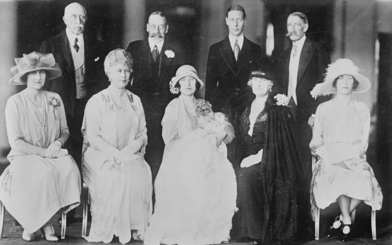 Family group photographic portrait taken after the christening of Princess Elizabeth of York, including her parents, grandparents, and godparents.