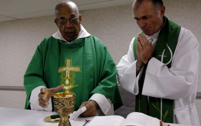 PORT-OF-SPAIN, Trinidad and Tobago (Sept. 21, 2007) - Father Joseph Harris, left, a Roman Catholic priest in Trinidad and Tobago, celebrates mass with Lt. Cmdr. Paul Evers, a Navy chaplain and Roman Catholic priest, aboard Military Sealift Command hospital ship USNS Comfort (T-AH 20). Comfort is on a four-month humanitarian deployment to Latin America and the Caribbean providing medical treatment to patients in a dozen countries. U.S. Navy photo taken by Mass Communication Specialist 2nd Class Joan E. Kretschmer (RELEASED)