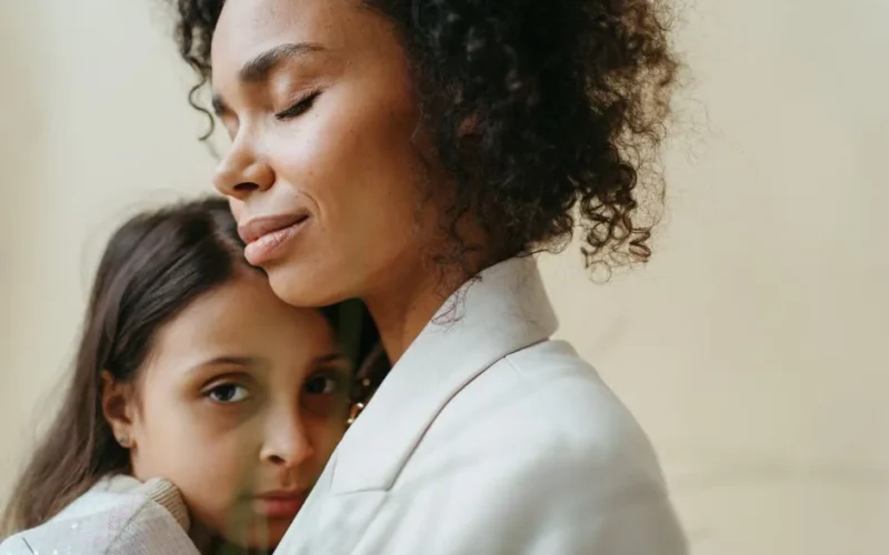 A mother and daughter share a tender embrace, expressing love and connection.