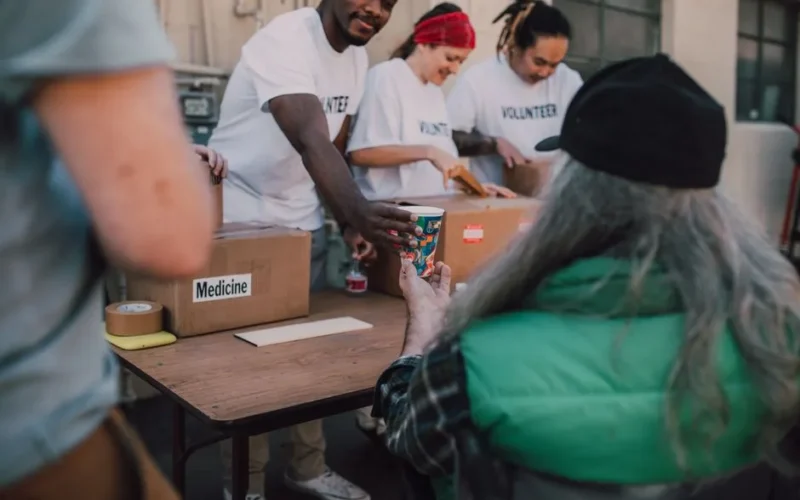 Volunteers handing out donations and support to those in need at a community event.