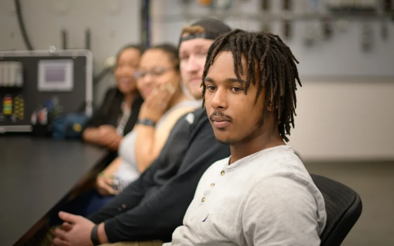 Students listen to Halifax Community College, Industrial Systems Technology Program, Department Head Jason Bowen discusses the importance of automated systems maintainers in the manufacturing industry in Weldon, NC, on May 23, 2023. The Advanced Manufacturing industry is considered a highly sought-after field in the region and throughout the state. Workforce skills such as working with diagnostic computer systems, programmable logic controllers, and a multimeter are highly desirable in this region. In an industry that increasingly depends on robotic systems, downtime is costly, and skilled technicians are essential to ensure that rural people thrive in rural America. The U.S. Department of Agriculture (USDA) Rural Development (RD) Rural Partners Network (RPN) utilizes a SMART project approach that includes examples such as this to develop talented and innovative people. - - - - - - - - - - - Northampton County is a member of the Upper Coastal Plains Council of Governments (COG), which follows the U.S. Department of Agriculture (USDA), Rural Development (RD), Rural Partners Network (RPN) SMART project approach. This approach has four key strategies, namely: 1. Building on each region's competitive advantage and leveraging the marketplace 2. Establishing and maintaining a robust regional infrastructure 3. Creating revitalized, healthy, and resilient communities 4. Developing talented and innovative people. RPN The Rural Partners Network (RPN) is a government program designed to assist rural communities in finding resources and funding to create jobs, construct infrastructure, and support long-term economic stability on their own terms. The RPN comprises federal agencies and commissions that work directly with rural communities to enhance rural prosperity through job creation, infrastructure development, and community improvement. Led by USDA Rural Development, RPN members collaborate to identify resources to help rural people build the futures they envision for the unique places they call home. RPN places federal staff on the ground in selected RPN Community Networks across the United States. RPN Liaisons work with small, rural communities to listen to their needs and understand the importance of the various funders and assistance providers to leverage their programs and resources and collaborate to achieve the communities' goals. Liaisons assist local people in navigating programs, building relationships, and identifying community-driven solutions. Participating RPN agencies and offices (rural.gov/about#block-views-block-partners-partners-listing) are also joining forces to promote rural priorities as federal programs and policies are developed to address funding gaps, increase access to technical assistance, and ensure equitable access to federal funding. For more information, please go to RURAL.gov, the official website of the Rural Partners Network. USDA Media by Lance Cheung.