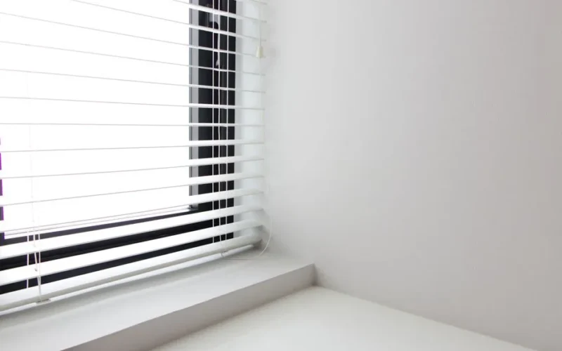 Bright minimalist interior with white window blinds and smooth wall, perfect for modern design.