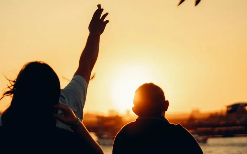 Two people watching a beautiful sunset, capturing the essence of peace and tranquility.