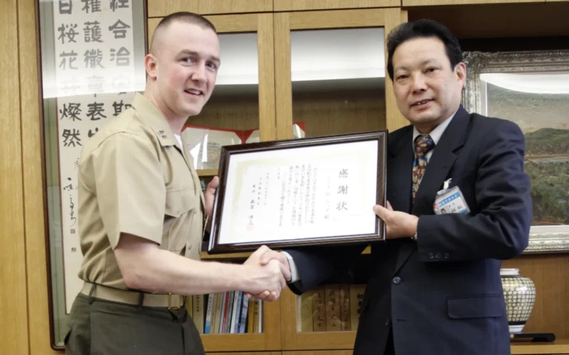 Capt. Jay M. Woods, operations officer at the Provost Marshal’s Office here, is presented with a letter of appreciation by Moritomi Hiroshi, chief of Iwakuni Police Department, at the Iwakuni Police Department April 12. The letter of appreciation commemorates Woods for the work he put forth to coordinate joint operations, such as Operation Total Shield, with the Iwakuni Police Department on and off base. His efforts to maintain communication, are professional relations with the Iwakuni Police Department has solidified a dual partnership between the air station and the city of Iwakuni.