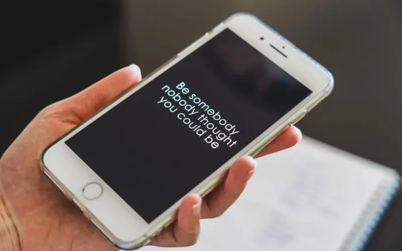 Close-up view of a smartphone displaying an inspirational quote, perfect for motivation and technology concepts.