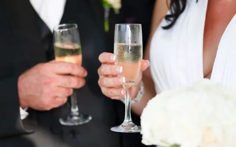 Bride and groom toasting with champagne at their wedding celebration.
