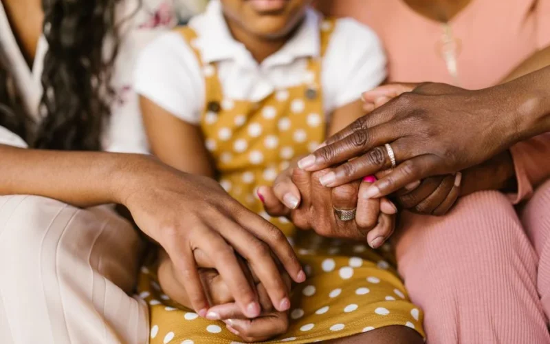 A close-up view of loving family hands holding together, symbolizing unity and support.
