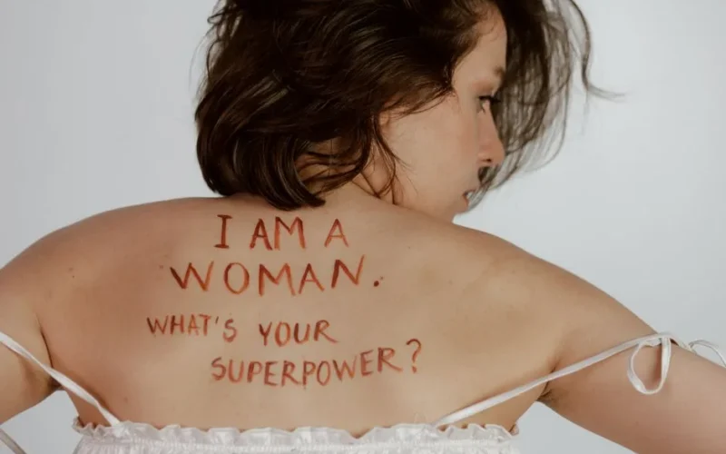Back view of woman with empowering message, promoting self-love and feminism.