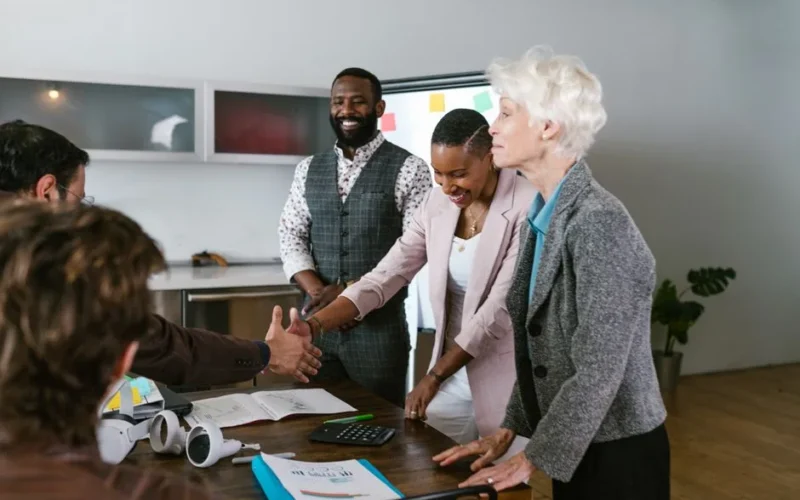A group of diverse professionals engaged in a collaborative business meeting indoors.