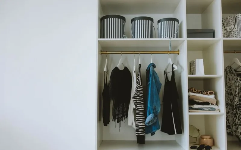 Organized wardrobe with trendy clothes, hangers, and storage boxes.