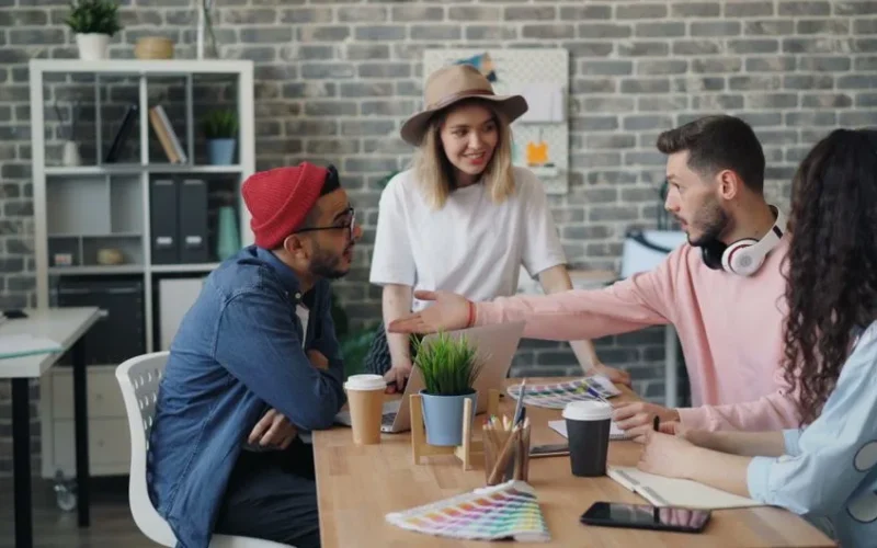 Group of young professionals brainstorming ideas in a modern office environment.