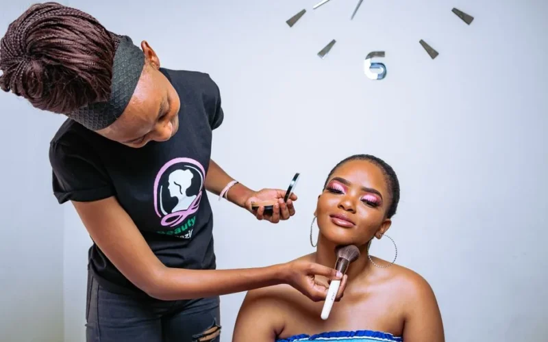 A makeup artist skillfully applies cosmetics to enhance her client's beauty in a salon setting.