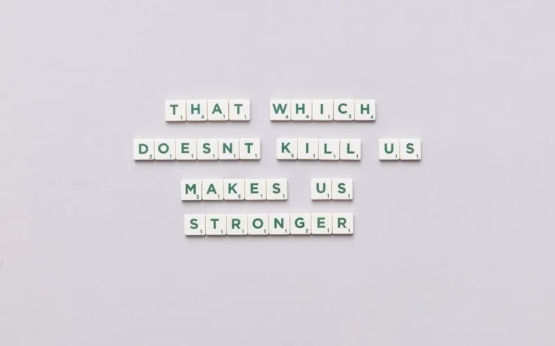Inspirational quote using Scrabble tiles on a light background, perfect for motivational content.