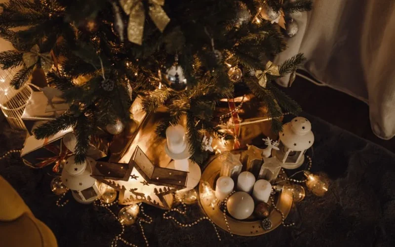 Warm Christmas scene with decorated tree, candles, and festive gifts under soft lighting.