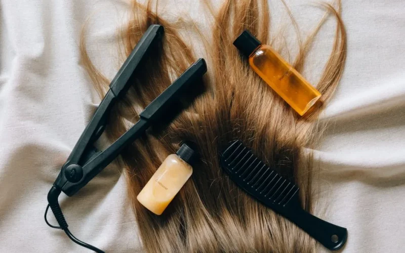 Aesthetic flat lay of hair products and tools for styling and grooming.