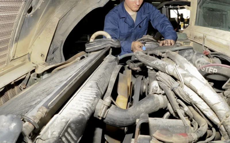 U.S. Air Force Airman 1st Class Sean Goddard, 380th Expeditionary Logistics Readiness Squadron vehicle mechanic, installs an air-line from the air filter to the intake manifold on a Humvee at an undisclosed location in Southwest Asia, June 19, 2013. The air-line will allow clean airflow to reach the vehicles engine. Goddard is native to Clinton, Iowa, and is deployed from Eielson Air Force Base, Alaska. (U.S. Air Force photo by Staff Sgt. Joshua J. Garcia/Released)