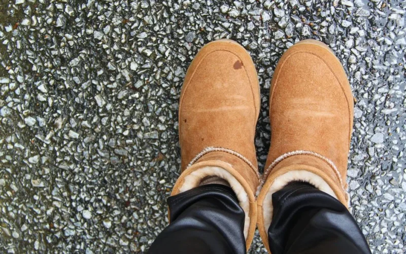 Warm suede boots on a textured asphalt background, captured from above.