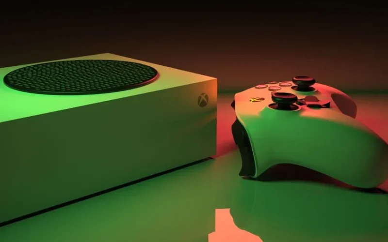 Close-up of an Xbox Series console and controller with dynamic lighting, showcasing modern gaming technology.